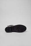 Underside of Camper Dean black and burgundy leather ankle boots showing the outsole pattern