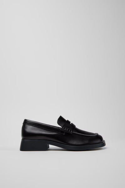 Side view of Camper Donna black leather loafers showing the low heel and contemporary silhouette