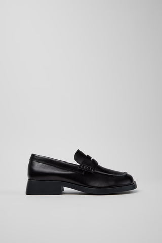 Side view of Camper Donna black leather loafers showing the low heel and contemporary silhouette