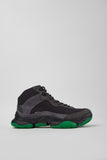 Side view of Camper Karst 2 men's black textile and nubuck sneakers showing the sculptural sole and green accents