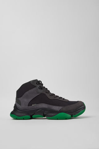 Side view of Camper Karst 2 men's black textile and nubuck sneakers showing the sculptural sole and green accents