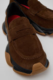 Close-up of Camper Karst 2 brown suede moccasins showing the textured upper, strap detail and contrasting sole