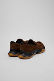 Rear three-quarter view of Camper Karst 2 brown suede moccasins showing the sculptural heel and rubber sole