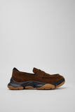 Side view of Camper Karst 2 brown suede moccasins showing the sculptural black and tan rubber sole