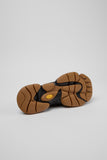 Underside of Camper Karst 2 brown suede moccasins showing the black and tan rubber outsole and tread pattern
