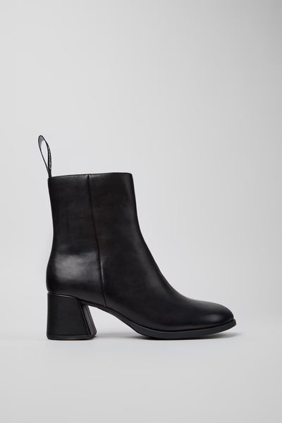 Side view of Camper Kora black leather ankle boots showing the sculptural block heel and rounded toe