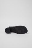 Underside of Camper Kora black leather ankle boots showing the outsole design