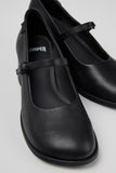 Close-up of Camper Kora black leather shoes showing the rounded toe and buckle strap