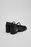 Rear three-quarter view of Camper Kora black leather shoes showing the sculptural block heels