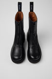 Close-up of Camper Milah black leather ankle boots showing the leather upper and construction details