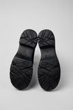 Rear view of Camper Milah black leather ankle boots showing the heel and ankle-height shaft