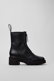Side view of Camper Milah black leather ankle boots showing the chunky sole and sculptural silhouette