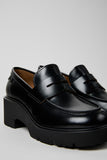Close-up of Camper Milah black leather moccasins showing the leather upper and moccasin detailing