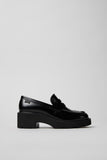 Side view of Camper Milah black leather moccasins showing the substantial sole and chunky silhouette
