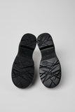Outsole view of Camper Milah black leather moccasins showing the tread pattern