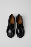 Top view of Camper Milah black leather moccasins showing the toe shape and upper design