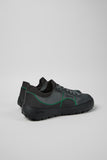 Rear three-quarter view of Camper Peu Serra grey textile sneakers showing the heel construction and rubber sole