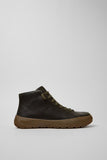 Side view of Camper Peu Serra men's green leather ankle boots showing the rugged Vibram rubber sole and rounded silhouette