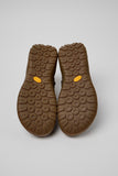 Underside of Camper Peu Serra green leather ankle boots showing the Vibram rubber outsole and tread pattern