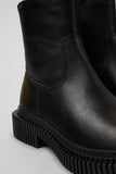 Close-up of Camper Pix Berlin black and brown leather ankle boots showing the leather upper, stitching and contrasting details