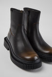 Close-up of Camper Pix Berlin black leather ankle boots showing the smooth calfskin upper and design details