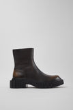 Side view of Camper Pix Berlin black leather ankle boots showing the sculptural sole and ankle-high silhouette