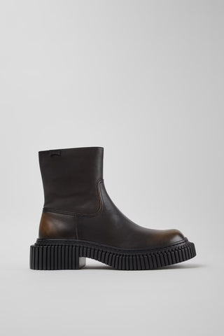 Side view of Camper Pix Berlin black leather ankle boots showing the sculptural sole and ankle-high silhouette