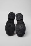 Underside of Camper Pix Berlin black leather ankle boots showing the outsole design