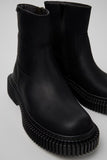 Close-up of Camper Pix Berlin black nubuck ankle boots showing the textured leather upper and sole detailing
