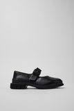 Side view of Camper Pix black leather ballerinas showing the Mary Jane strap and substantial sole