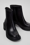 Close-up of Camper Pix London black leather ankle boots showing the calfskin upper and design details
