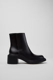 Side view of Camper Pix London black leather ankle boots showing the sculptural heel and sleek ankle silhouette