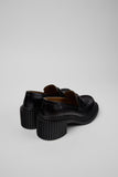 Rear three-quarter view of Camper Pix London black leather heeled loafers showing the heel and side profile