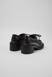 Rear three-quarter view of Camper Pix London black leather heeled loafers showing the shaped heel and sole profile
