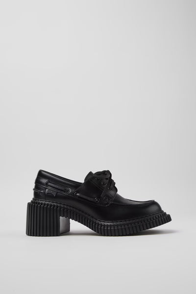 Side view of Camper Pix London black leather heeled loafers showing the sculptural sole and raised heel