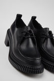 Close-up of Camper Pix London black leather heeled shoes showing the leather finish and construction details