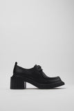 Side view of Camper Pix London black leather heeled shoes showing the sculptural 7 cm heel and structured silhouette