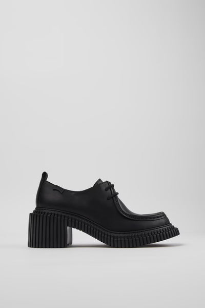 Side view of Camper Pix London black leather heeled shoes showing the sculptural 7 cm heel and structured silhouette