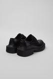 Rear three-quarter view of Camper Twins black leather shoes showing their heel and sole profiles