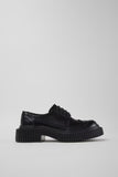 Side view of Camper Twins black leather shoes showing their contemporary silhouette and sculptural sole