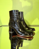 Angled view of Chie Mihara TALENA black croc-embossed leather ankle boots