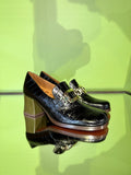 Angled view of Chie Mihara TEIL black and ocher leather shoes