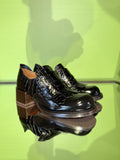 Angled view of Chie Mihara XUDAI black croc-embossed leather shoes