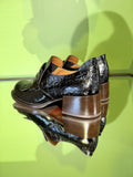 Rear view of Chie Mihara XUDAI black leather shoes with low covered heel