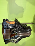 Side view of Chie Mihara XUDAI black croc-embossed leather shoes